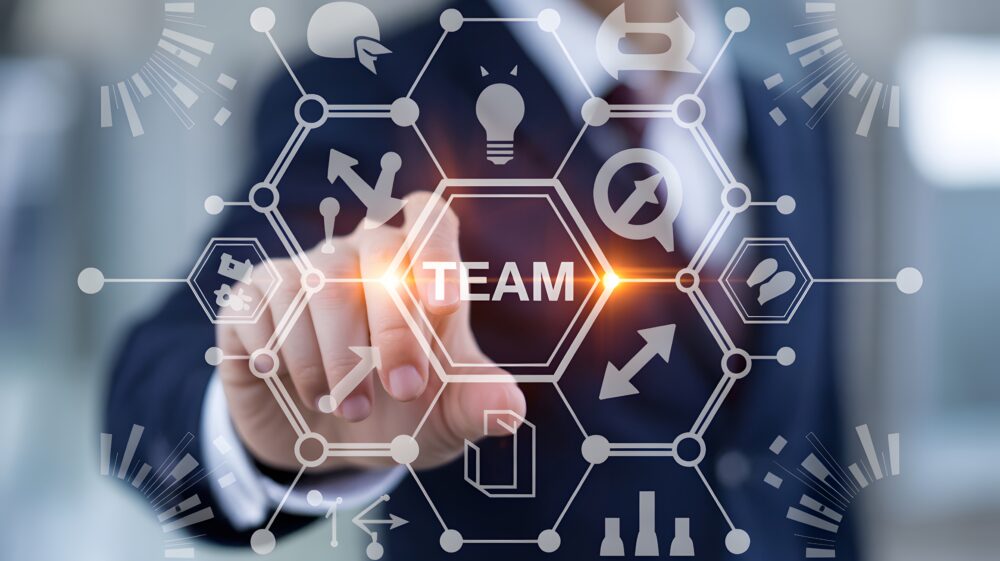 Professional interacting with a futuristic digital interface to foster business team collaboration